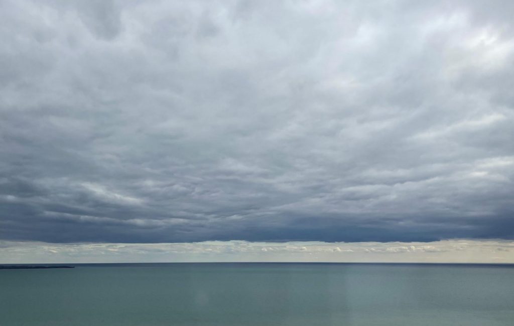 sky and Lake Ontario in a dance of blues and the vision of an upside down world at play
